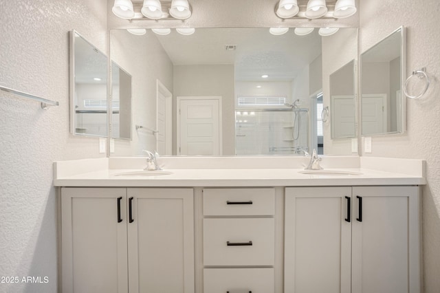 3523 W Rhapsody Dr, Sierra Vista, AZ 85650 - bathroom with a sink, a textured wall, a stall shower, and double vanity