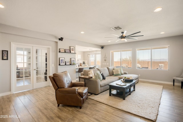 3523 W Rhapsody Dr, Sierra Vista, AZ 85650 - living area with visible vents, ceiling fan, wood finished floors, and french doors