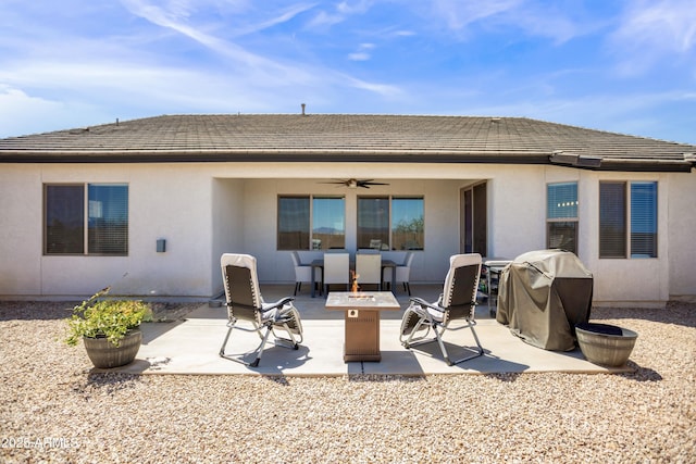 3523 W Rhapsody Dr, Sierra Vista, AZ 85650 - back of property with ceiling fan, stucco siding, a fire pit, and a patio area
