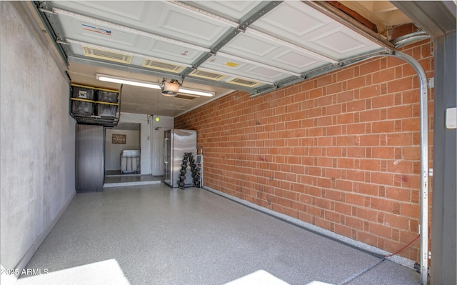 garage with freestanding refrigerator and a garage door opener