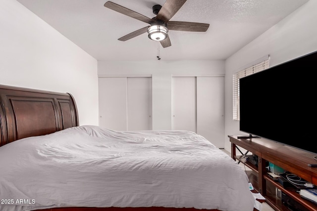 bedroom featuring multiple closets and a ceiling fan