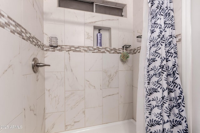 bathroom with a tile shower