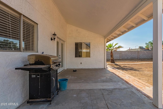 view of patio featuring fence and area for grilling