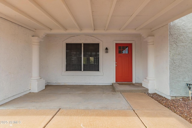 view of exterior entry with stucco siding