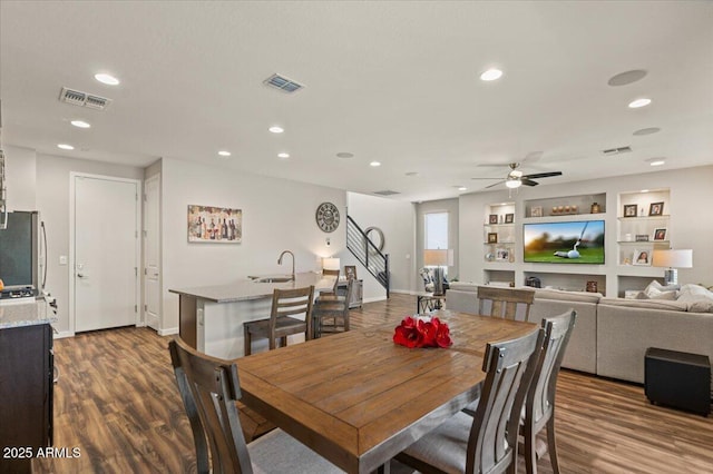 dining space featuring wood finished floors, stairway, recessed lighting, ceiling fan, and baseboards