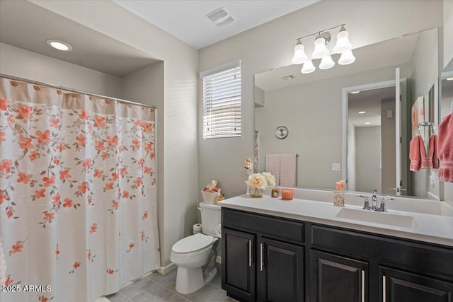 bathroom with toilet, tile patterned flooring, and vanity