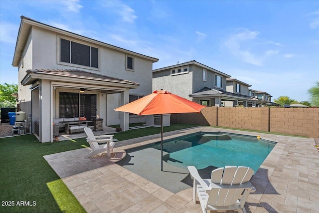 view of swimming pool with outdoor lounge area, a patio, and ceiling fan