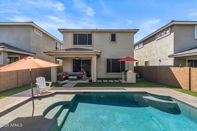 back of property featuring outdoor lounge area, stucco siding, a fenced backyard, and a patio area