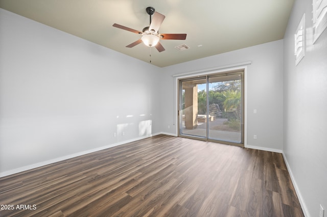 empty room featuring dark hardwood / wood-style flooring and ceiling fan