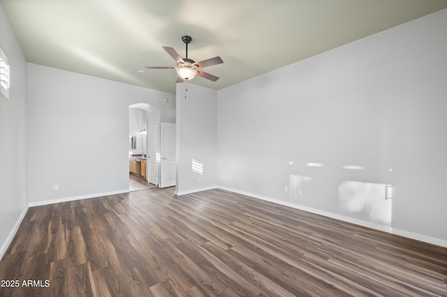 spare room with vaulted ceiling, dark hardwood / wood-style floors, and ceiling fan