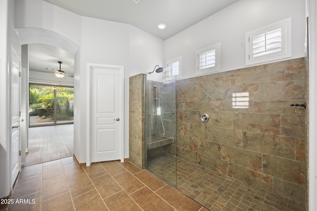 bathroom with tile patterned flooring, ceiling fan, plenty of natural light, and tiled shower