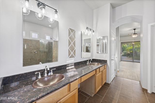 bathroom with vanity, ceiling fan, tile patterned flooring, and a shower