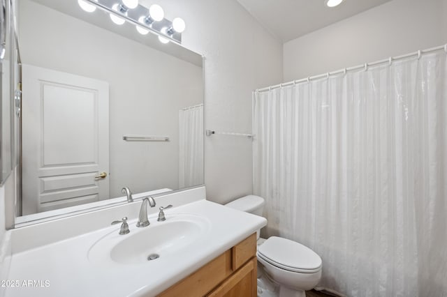 bathroom with vanity, toilet, and curtained shower