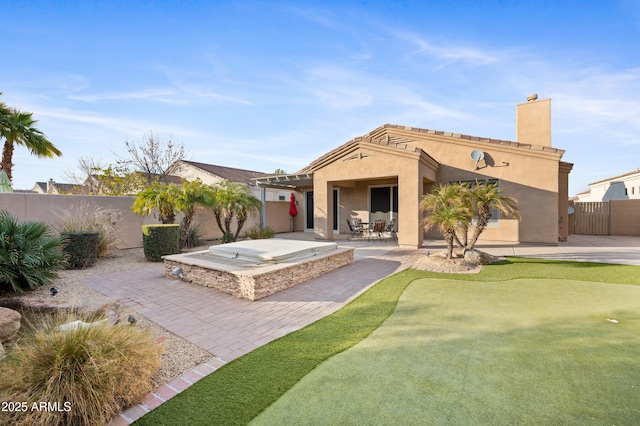 back of property with a patio