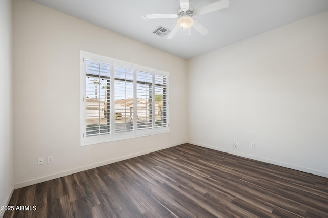 spare room with dark hardwood / wood-style flooring and ceiling fan