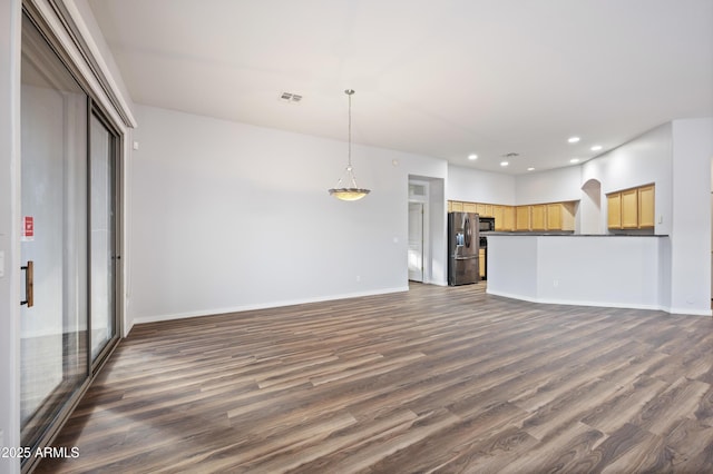 unfurnished living room featuring dark hardwood / wood-style flooring