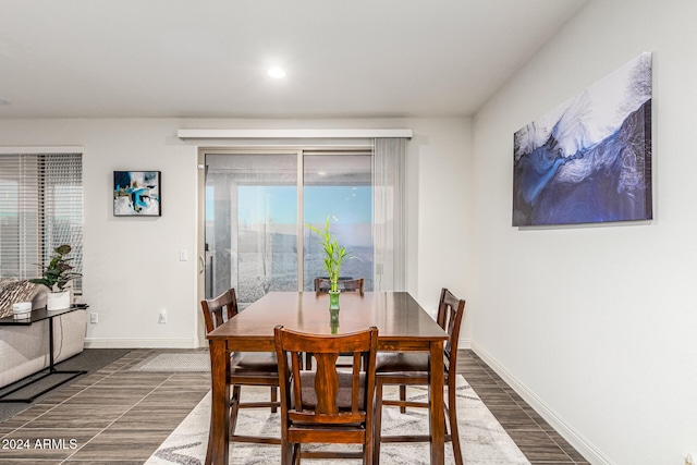 dining space with dark hardwood / wood-style flooring