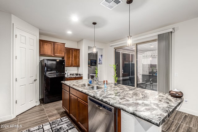 kitchen featuring black refrigerator, stainless steel dishwasher, sink, pendant lighting, and a center island with sink