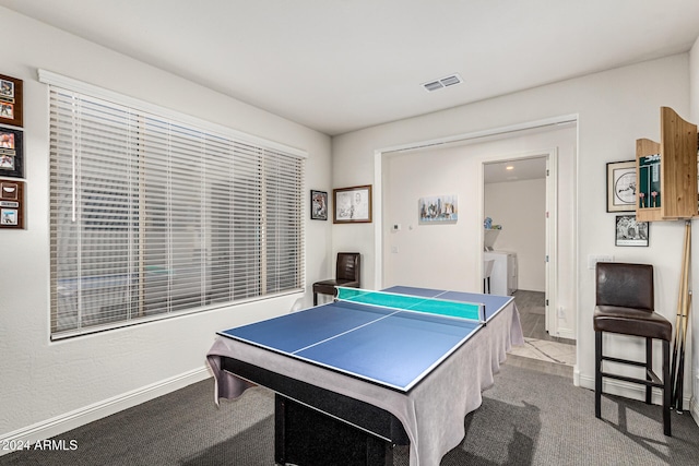 recreation room with light colored carpet