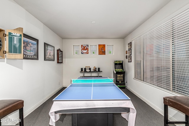 recreation room featuring dark carpet