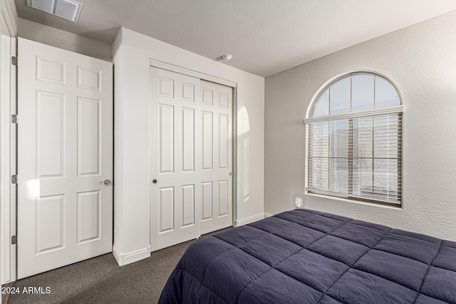 carpeted bedroom with a closet