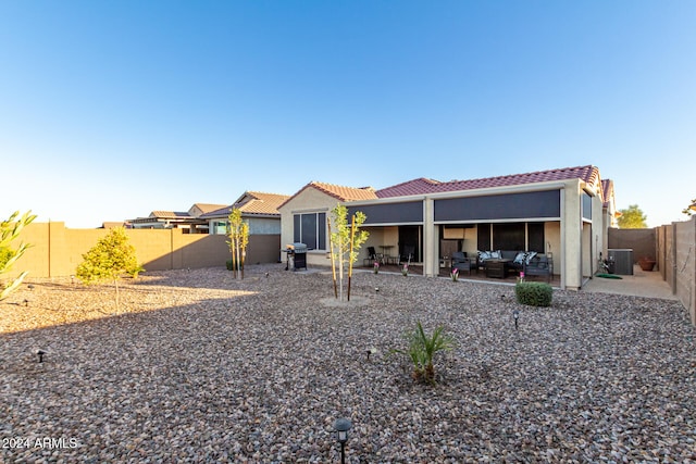 back of property featuring central AC unit, an outdoor hangout area, and a patio