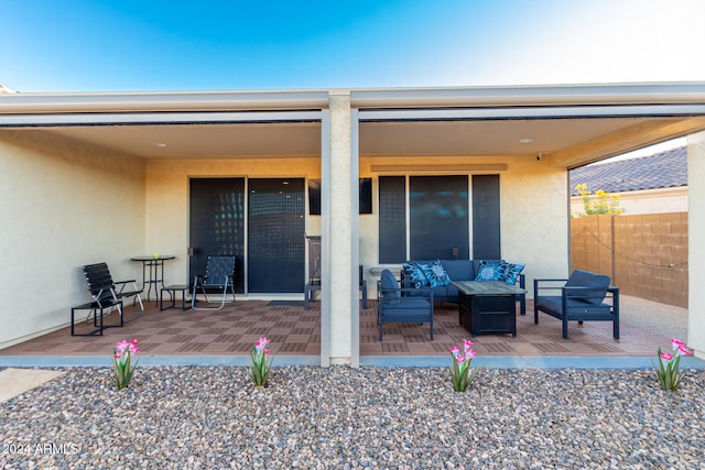 exterior space with an outdoor hangout area and a patio