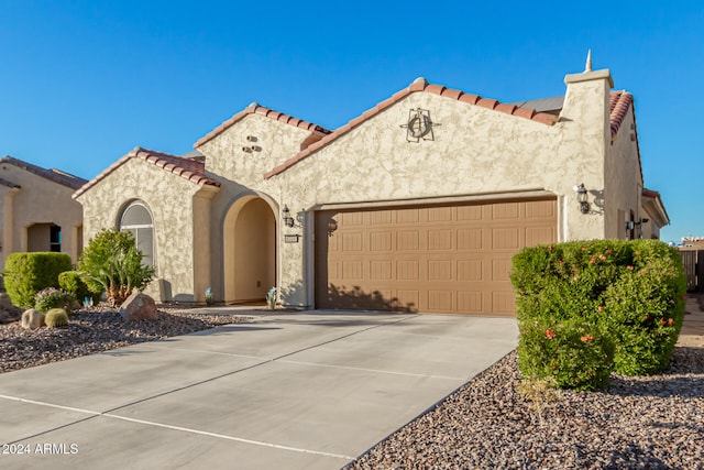 mediterranean / spanish-style home featuring a garage