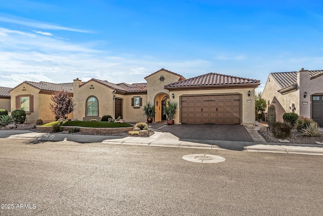 mediterranean / spanish-style home featuring a garage