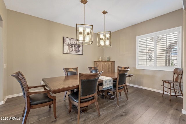 dining room featuring dark hardwood / wood-style flooring and a chandelier