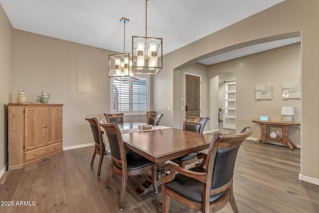 dining room featuring light hardwood / wood-style flooring and a notable chandelier