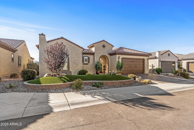 mediterranean / spanish house featuring a garage