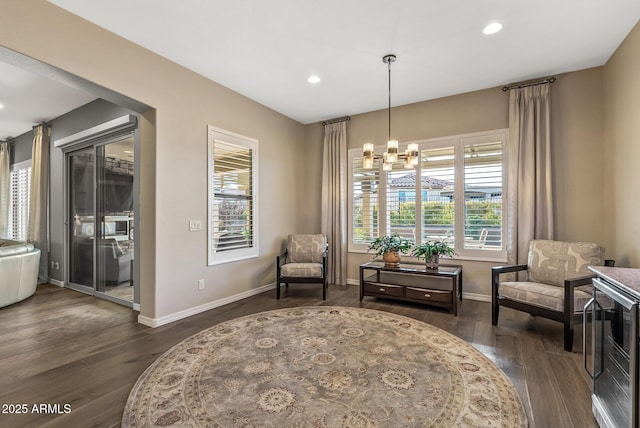 living area featuring a chandelier and dark hardwood / wood-style floors