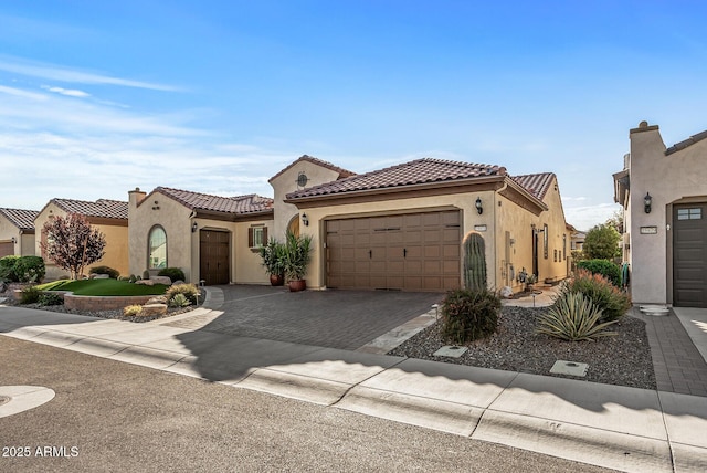 mediterranean / spanish-style home with a garage