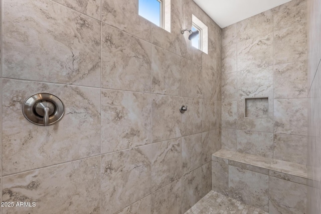 bathroom with a tile shower