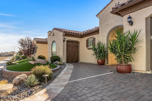 view of exterior entry featuring a garage