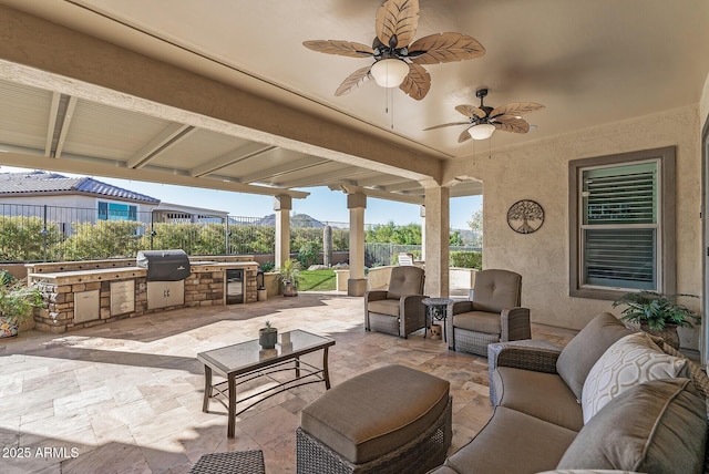 view of patio / terrace with ceiling fan, area for grilling, an outdoor living space, and a grill