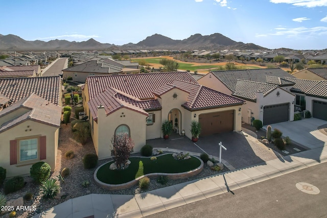 mediterranean / spanish-style house featuring a mountain view and a garage