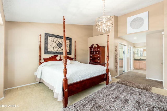 carpeted bedroom featuring connected bathroom, vaulted ceiling, and an inviting chandelier