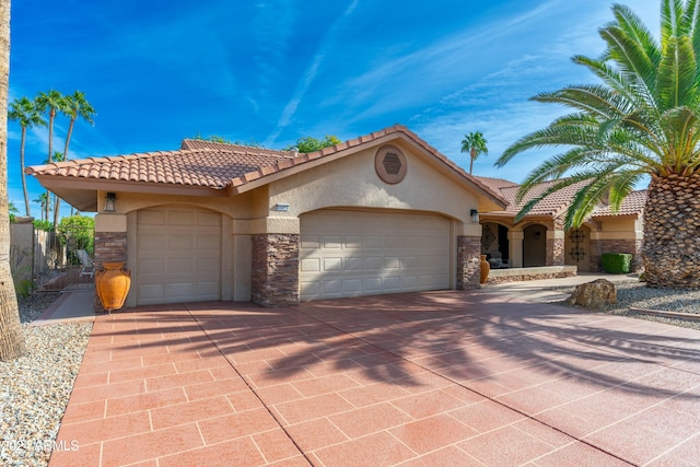 mediterranean / spanish house with a garage