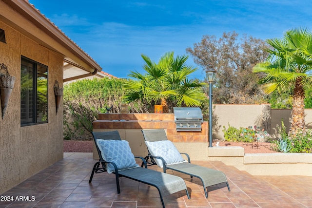 view of patio featuring area for grilling and an outdoor kitchen