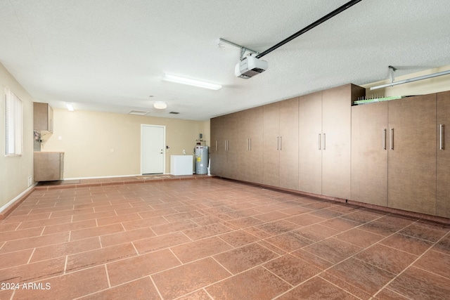 garage with electric water heater, a garage door opener, and washer / dryer