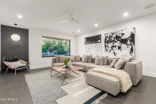 living area featuring baseboards, ceiling fan, and recessed lighting