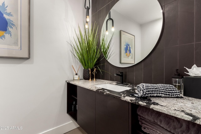 bathroom with vanity and baseboards