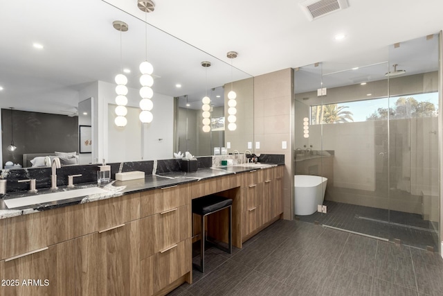 bathroom with a shower stall, double vanity, tile patterned flooring, a freestanding bath, and tile walls