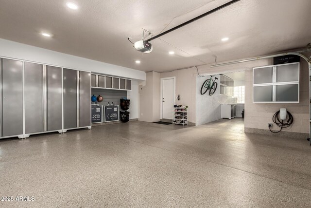 garage featuring a garage door opener and recessed lighting