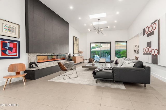 living room featuring high vaulted ceiling, a skylight, a tile fireplace, light tile patterned flooring, and recessed lighting