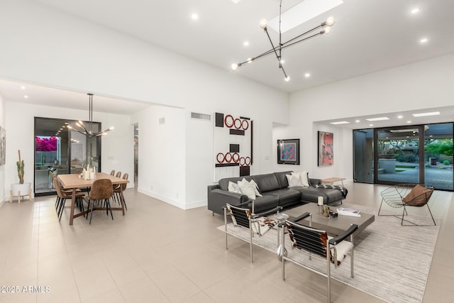 living room with a chandelier, baseboards, and recessed lighting