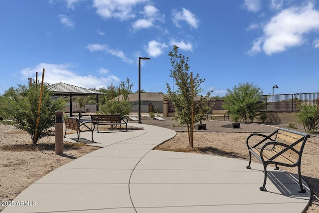 surrounding community with fence and a gazebo