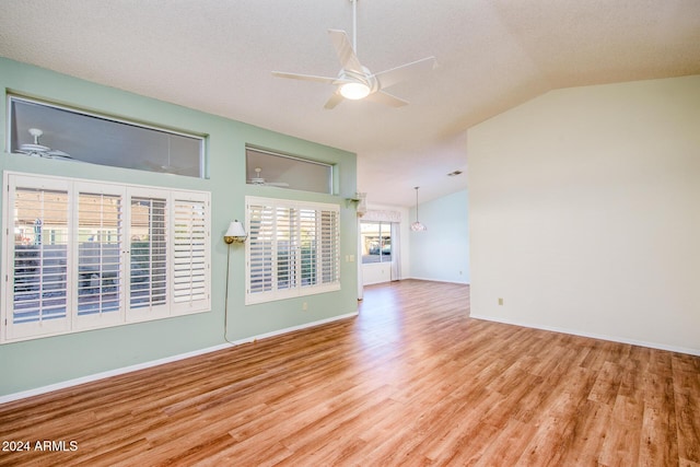 unfurnished room featuring baseboards, a ceiling fan, lofted ceiling, and wood finished floors